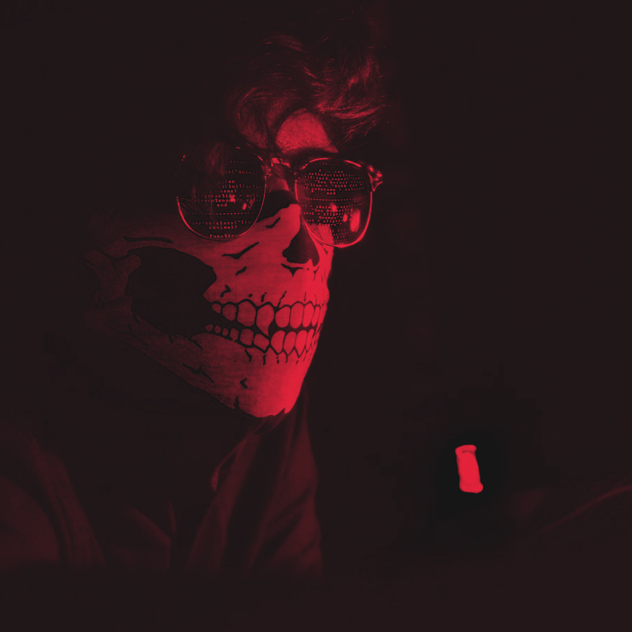 A masked guy stares at computer