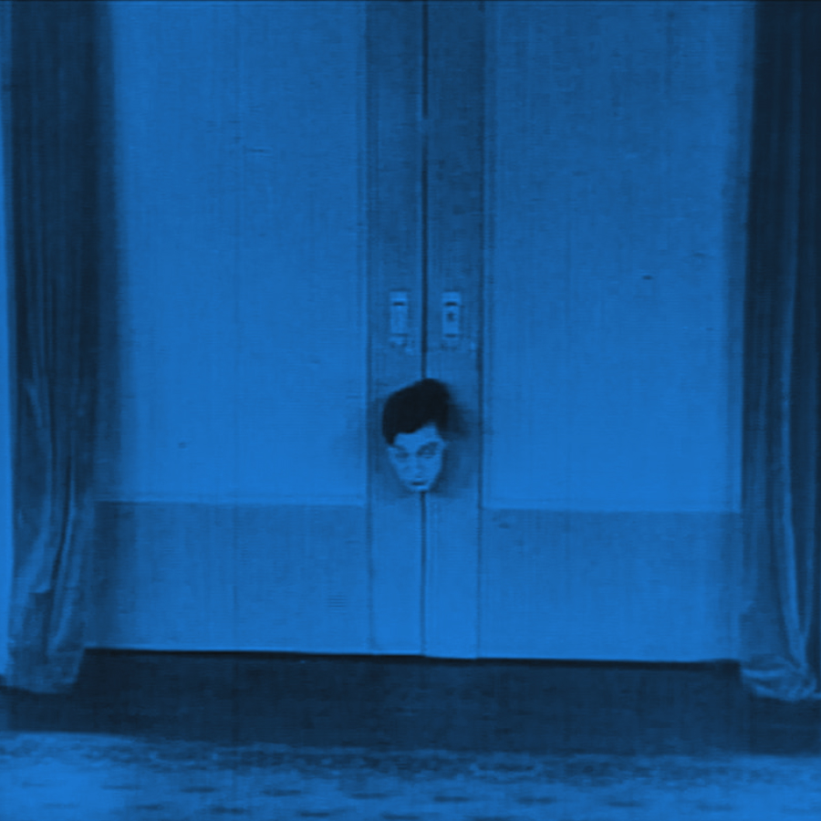 Buster Keaton trapped in an automatic door by his electric house, from The Electric House (1922)